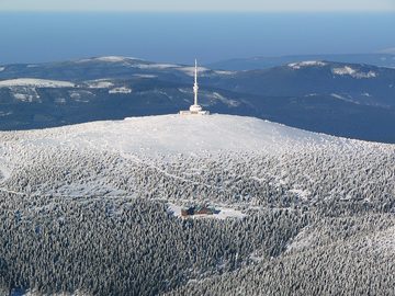 Praděd with its snow-covered summit and transmitter, aerial photo